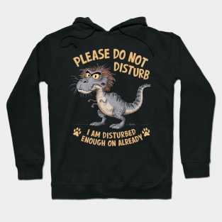 A whimsical cartoon drawing of a disheveled t-rex, with its fur sticking out in all directions and large yellow eyes showing irritation. Hoodie